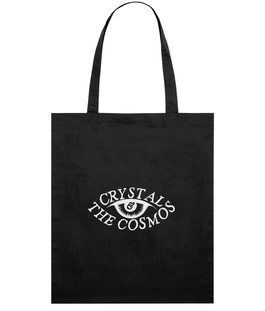 Black tote bag with 'Crystal & The Cosmos' logo printed in white.
